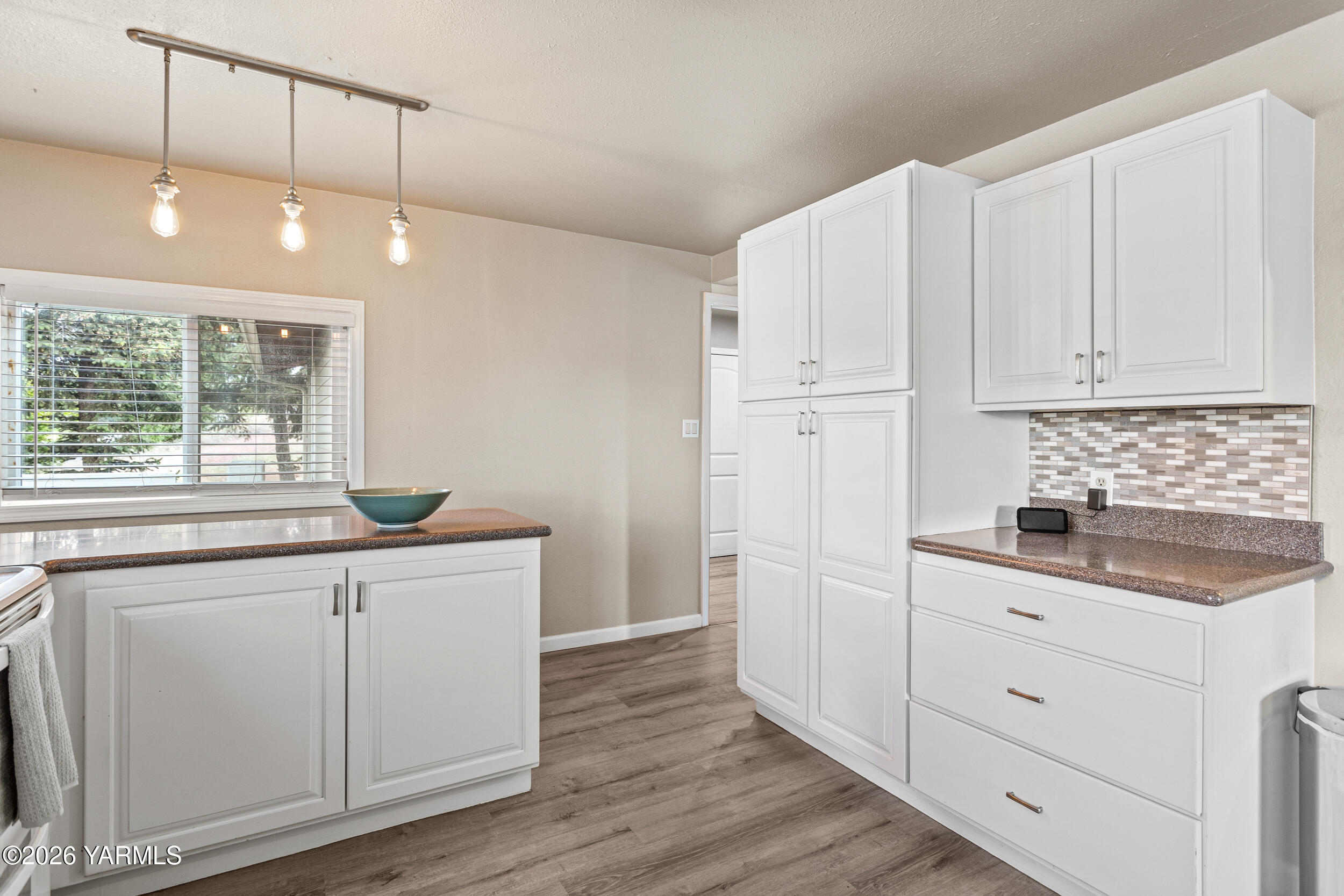 2121 Pleasant Hill Road Selah, WA 98942 - Photo 15 of 38 a kitchen with white cabinets and sink