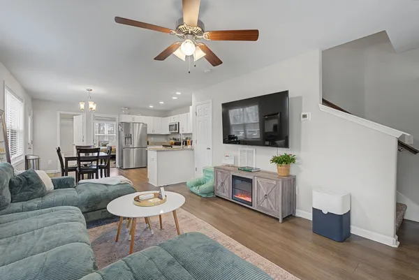 a kitchen with a sink a refrigerator and a stove top oven