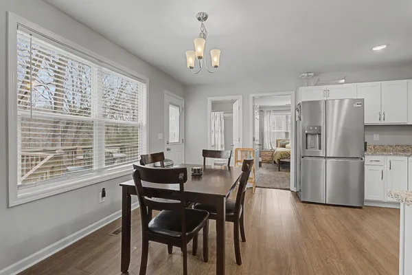 a kitchen with stainless steel appliances granite countertop a refrigerator a stove top oven a sink and dishwasher