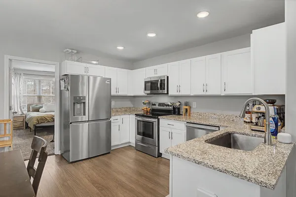 a kitchen with a table chairs stove and cabinets