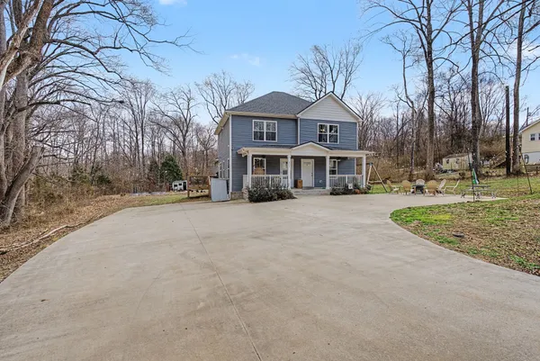 a view of a chairs and backyard with a slide