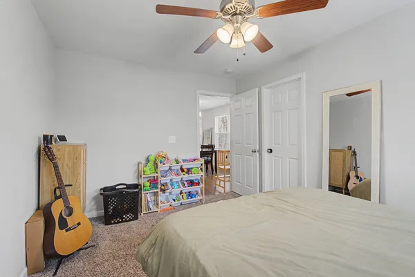 a living room with furniture a window and a flat screen tv