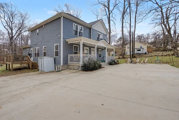a view of a house with backyard sitting area and garden