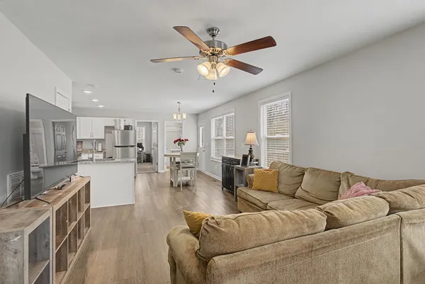 a kitchen with stainless steel appliances granite countertop a refrigerator sink and white cabinets
