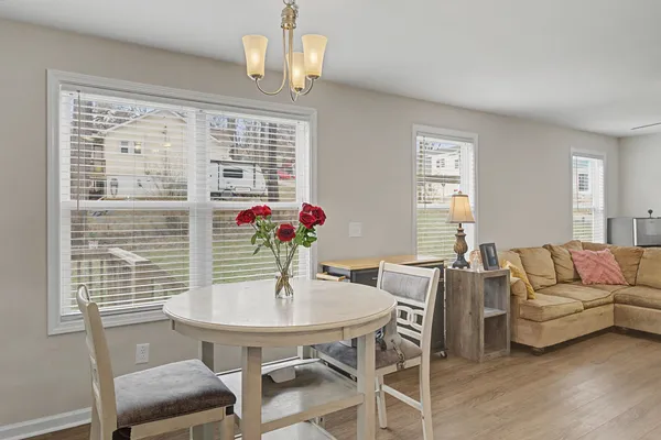 a view of a room with wooden floor and white walls
