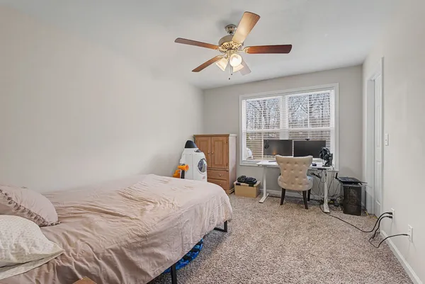 a room that has a bed and a chandelier