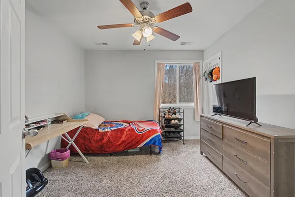 a view of a house with a yard and wooden fence