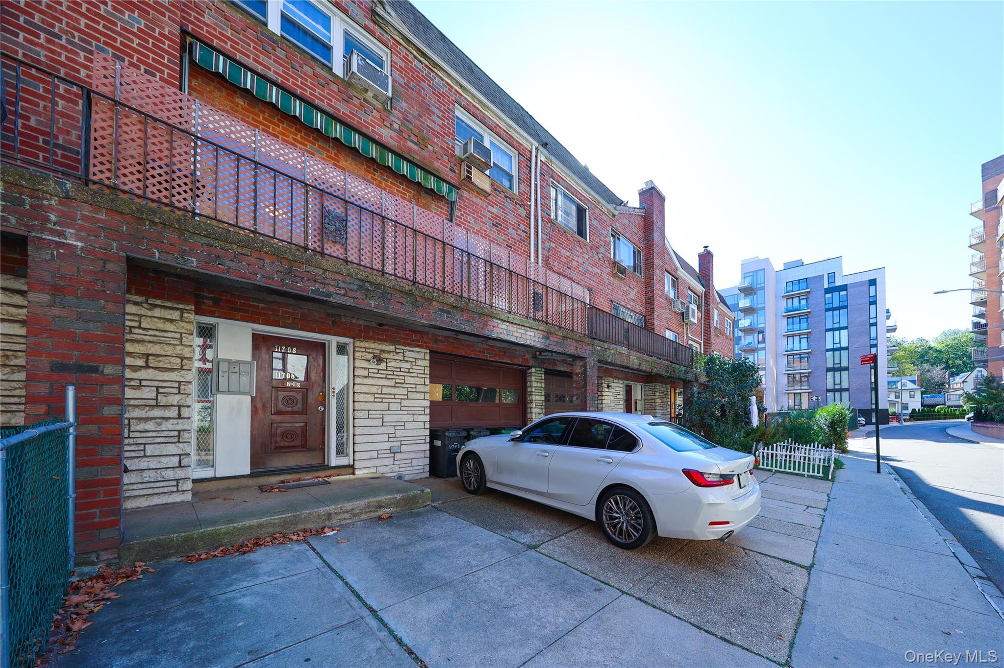 117-08 Curzon Road Queens, NY 11415 - Photo 1 of 1 View of building exterior featuring driveway and a garage