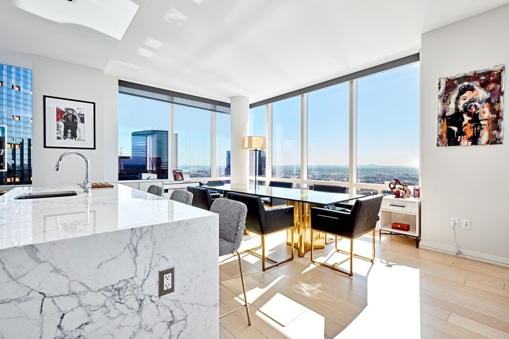 1 Franklin Street, Unit 4110 Boston, MA 02110 - Photo 4 of 22 a view of a dining room with furniture and a large window