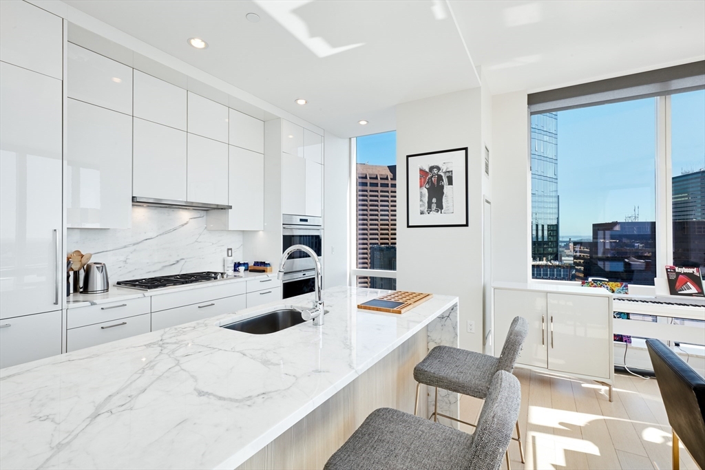 1 Franklin Street, Unit 4110 Boston, MA 02110 - Photo 5 of 22 a kitchen with a sink cabinets and wooden floor
