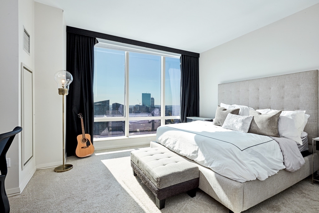 1 Franklin Street, Unit 4110 Boston, MA 02110 - Photo 6 of 22 a bedroom with a bed and wooden floor