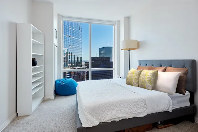 a bedroom with a bed and a television