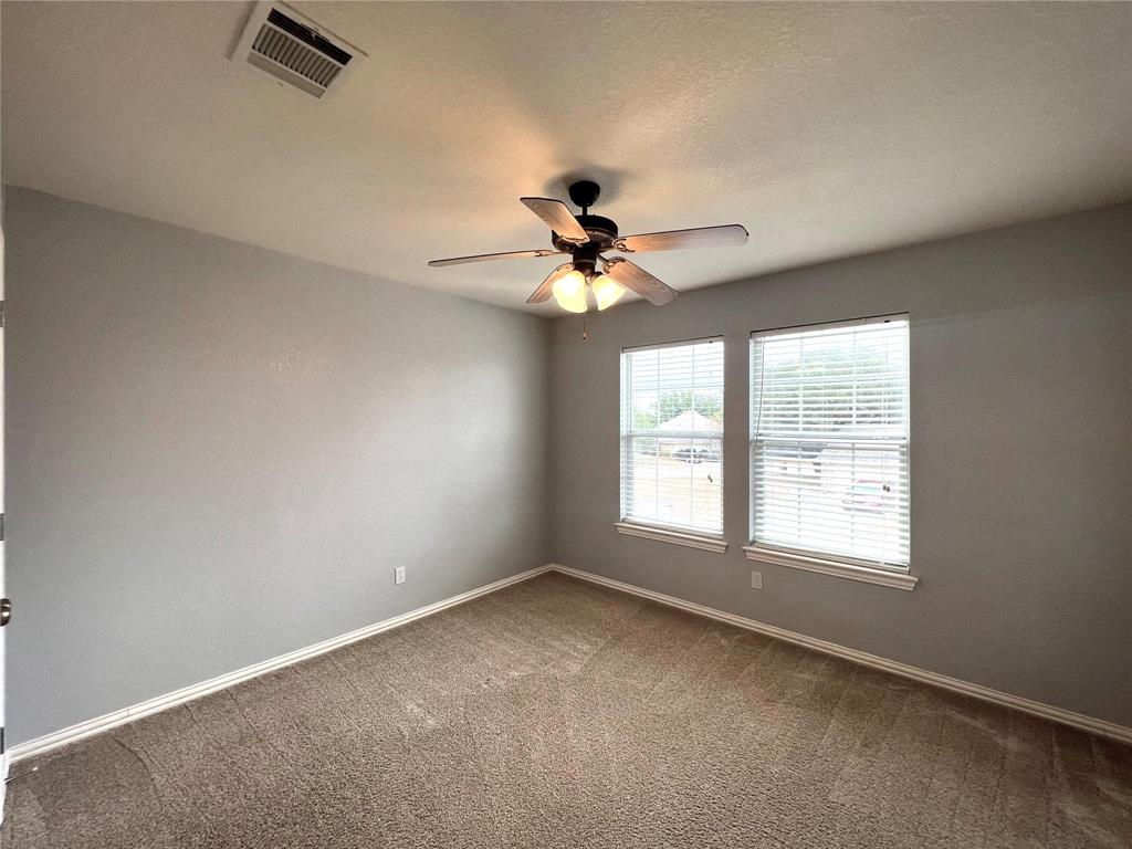 306 Howard Way Drive Aledo, TX 76008 - Photo 11 of 23 an empty room with chandelier fan and windows