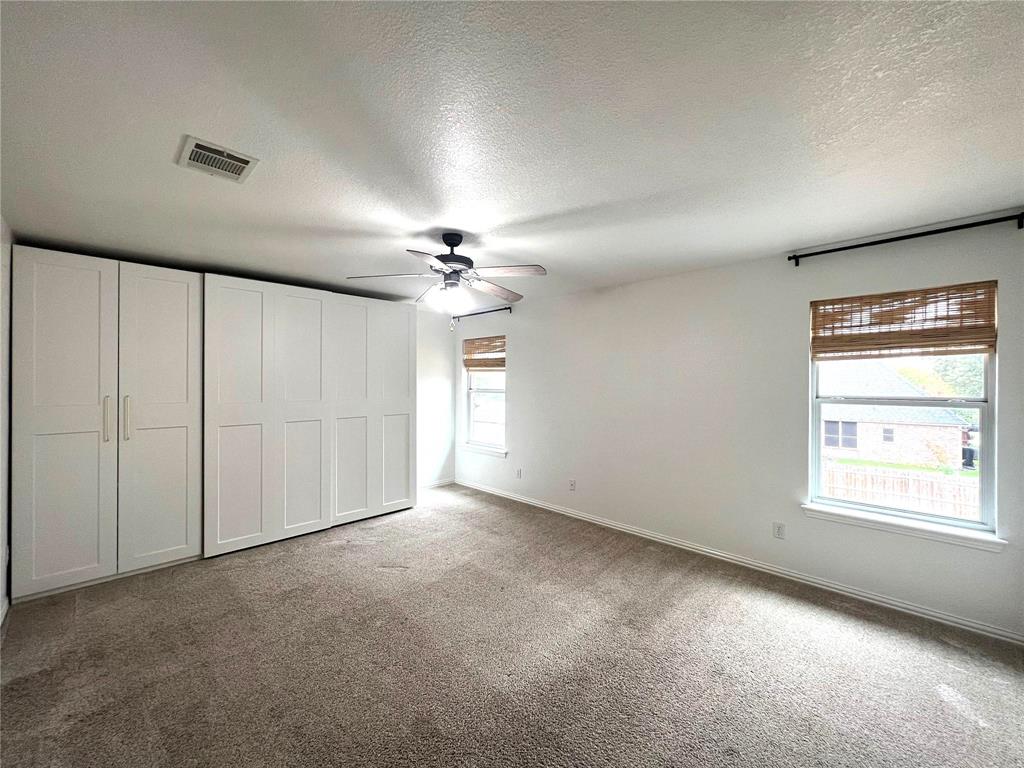 306 Howard Way Drive Aledo, TX 76008 - Photo 18 of 23 an empty room with chandelier fan and windows