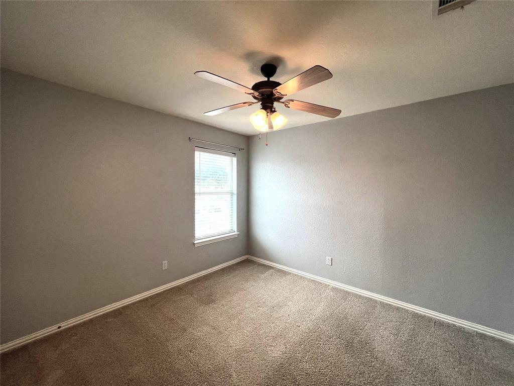 306 Howard Way Drive Aledo, TX 76008 - Photo 10 of 23 an empty room with windows and chandelier fan