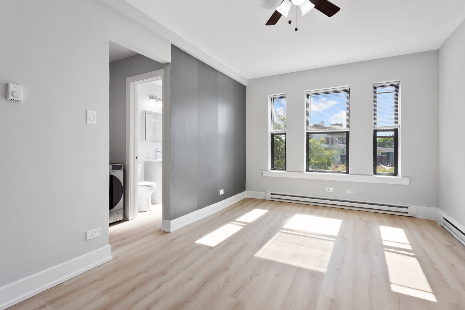 1634 West Howard Street, Unit 214 Chicago, IL 60626 - Photo 3 of 7 a view of an empty room with window and wooden floor