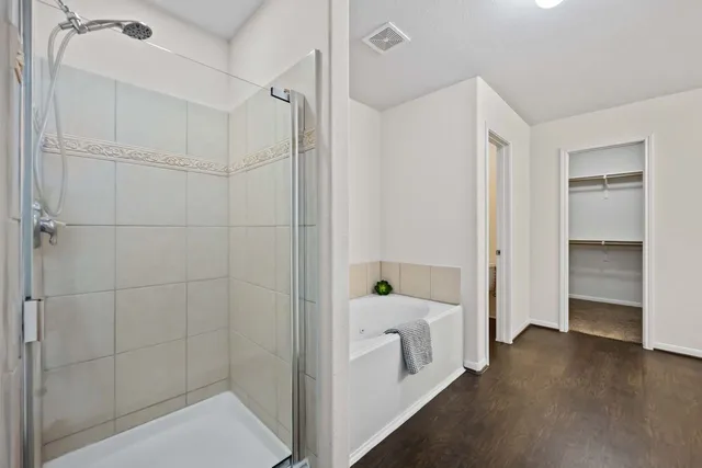 a spacious bathroom with a double vanity sink and a mirror