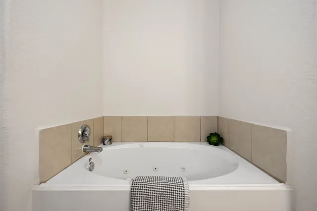 an empty room with closet and a ceiling fan