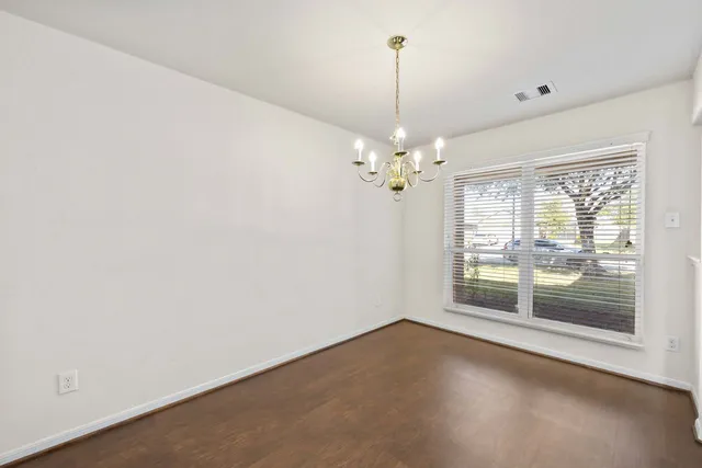 a kitchen with granite countertop a refrigerator and a stove top oven