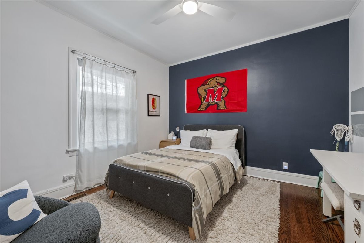 2215 Wesley Avenue Evanston, IL 60201 - Photo 21 of 52 a bedroom with a bed and a chandelier