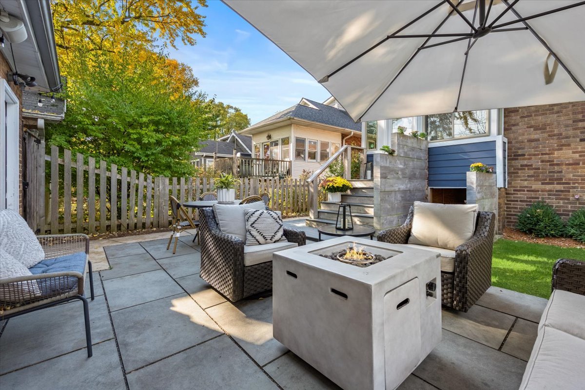 2215 Wesley Avenue Evanston, IL 60201 - Photo 45 of 52 a view of a patio with table and chairs under an umbrella