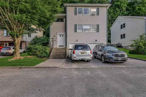 a car parked in front of white house