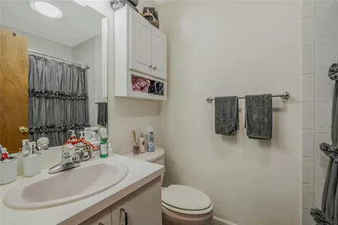 a bathroom with a sink toilet and mirror