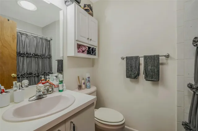 a bathroom with a sink toilet and mirror