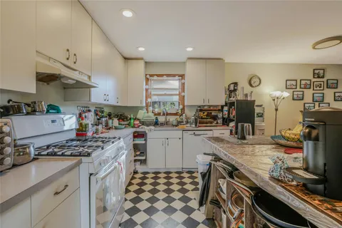 a kitchen with stove and cabinets