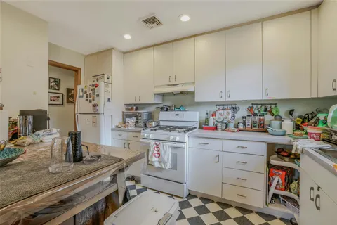 a kitchen with stainless steel appliances granite countertop a sink stove and cabinets