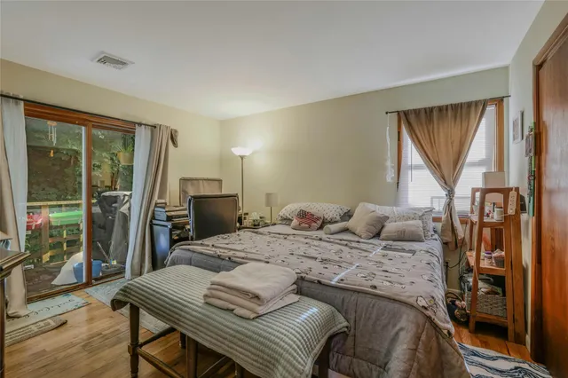 a bedroom that has a bed and a table in it