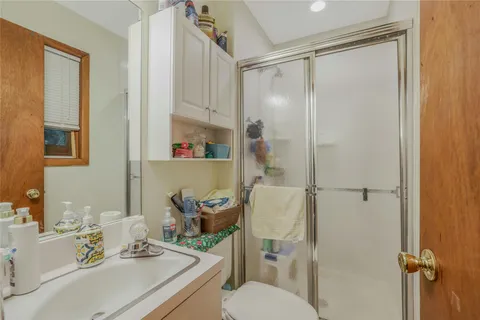 a bathroom with a sink toilet and shower