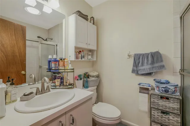 a bathroom with a sink a toilet and shower curtain
