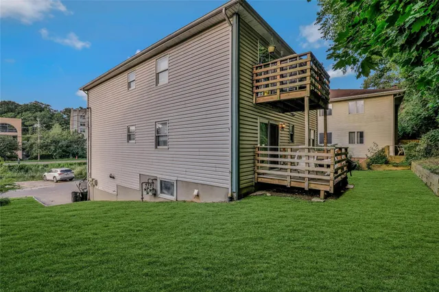 a view of a house with a yard and sitting area