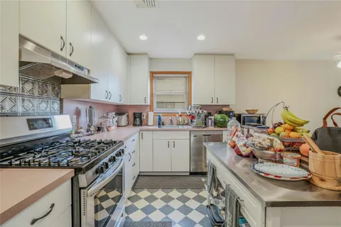 a kitchen with a sink stove and cabinets