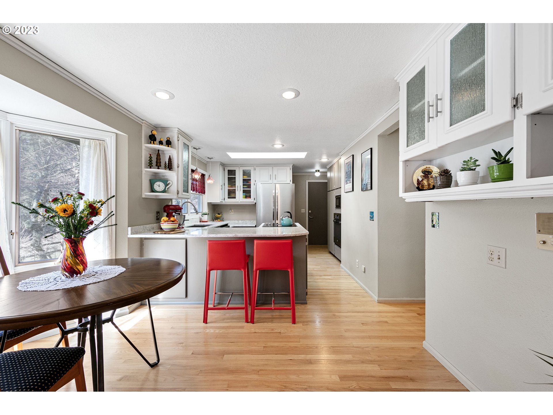 77914 Chisholm Trail Road Cottage Grove, OR 97424 - Photo 11 of 41 a open kitchen with stainless steel appliances kitchen island granite countertop a table chairs and a refrigerator