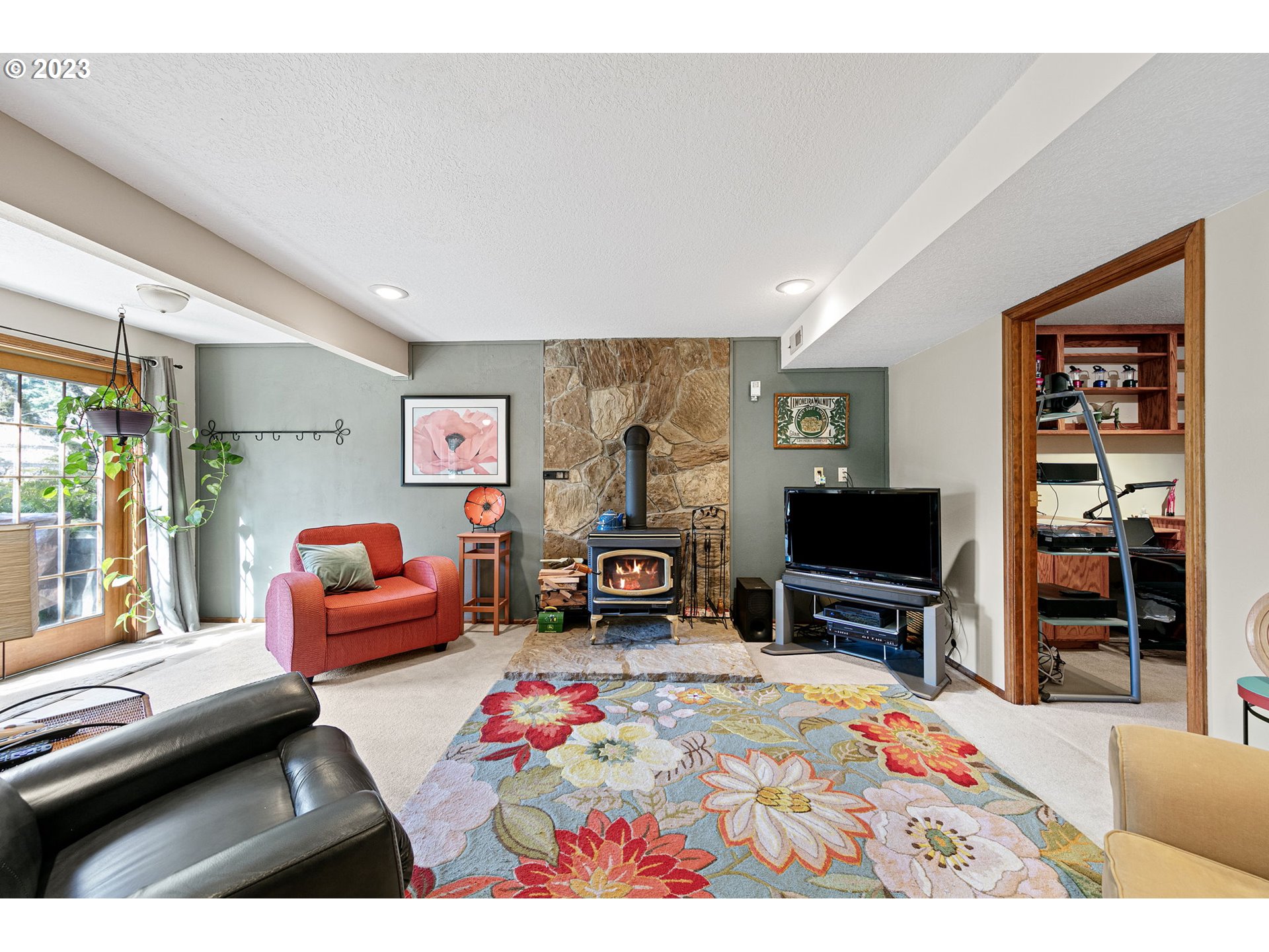 77914 Chisholm Trail Road Cottage Grove, OR 97424 - Photo 18 of 41 a bedroom with furniture a flat screen tv and a fireplace