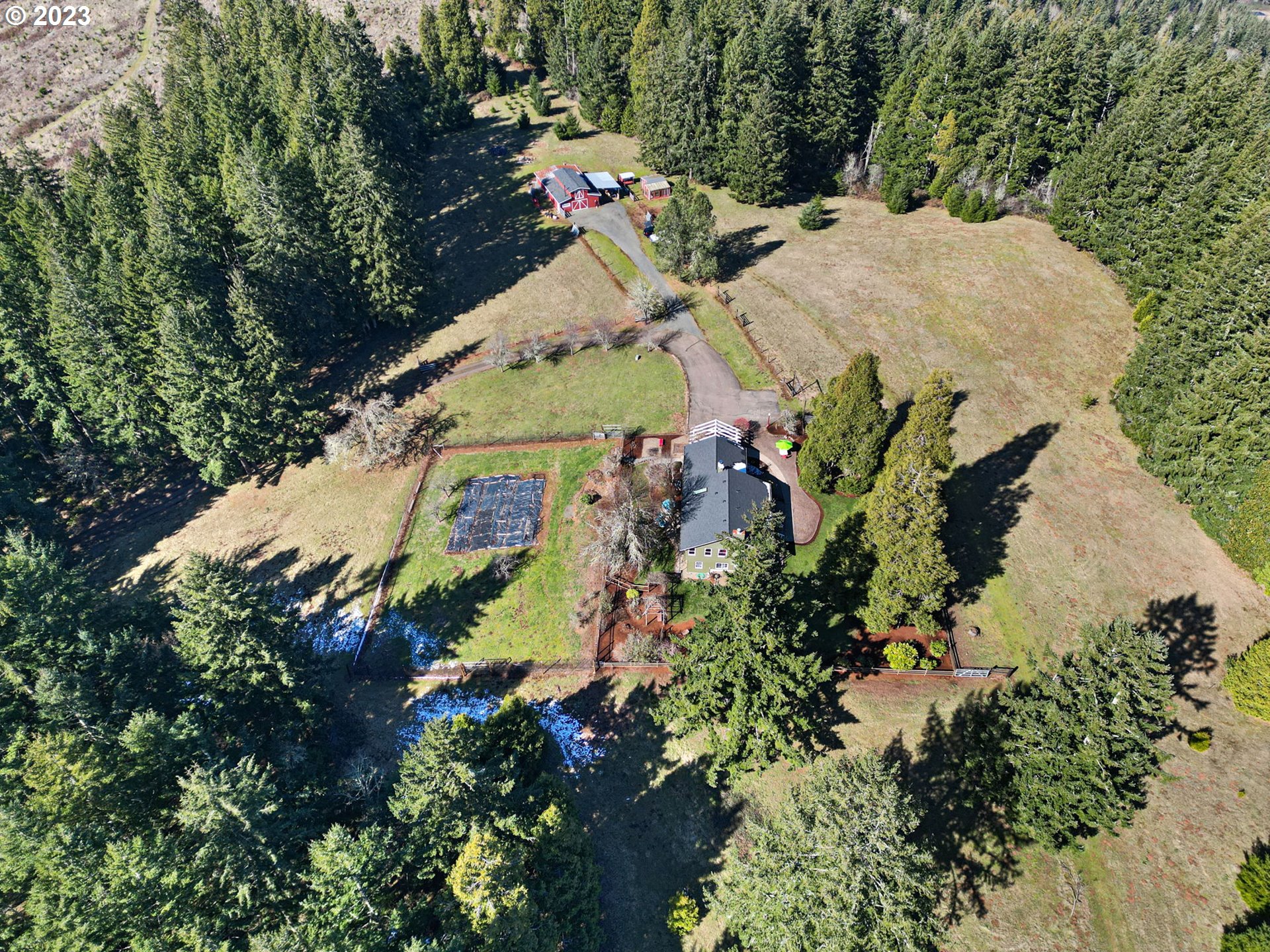 77914 Chisholm Trail Road Cottage Grove, OR 97424 - Photo 31 of 41 an aerial view of a house with a yard and large trees