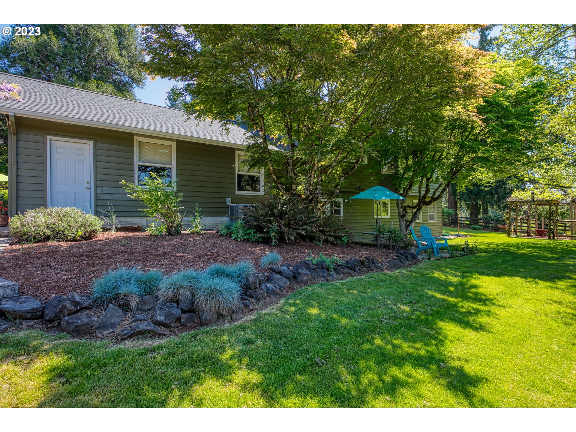77914 Chisholm Trail Road Cottage Grove, OR 97424 - Photo 35 of 41 a view of a house with backyard and garden