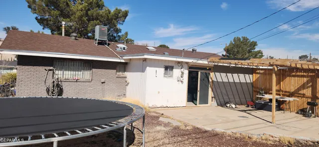 a view of a patio with table and chairs with wooden fence