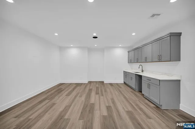 a view of a kitchen with wooden floor and electronic appliances