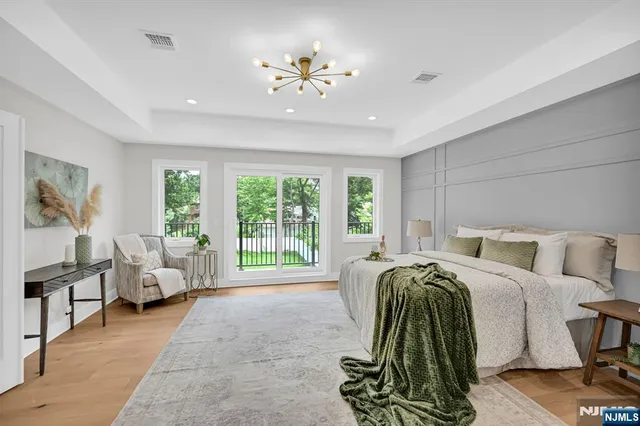 a bed room with a bed and a chandelier