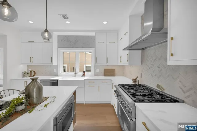 a kitchen with a white stove top oven sink and cabinets