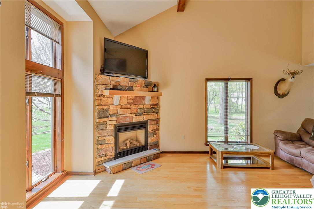 1208 Rone Drive Wind Gap, PA 18091 - Photo 12 of 78 a living room with furniture a flat screen tv and a fireplace