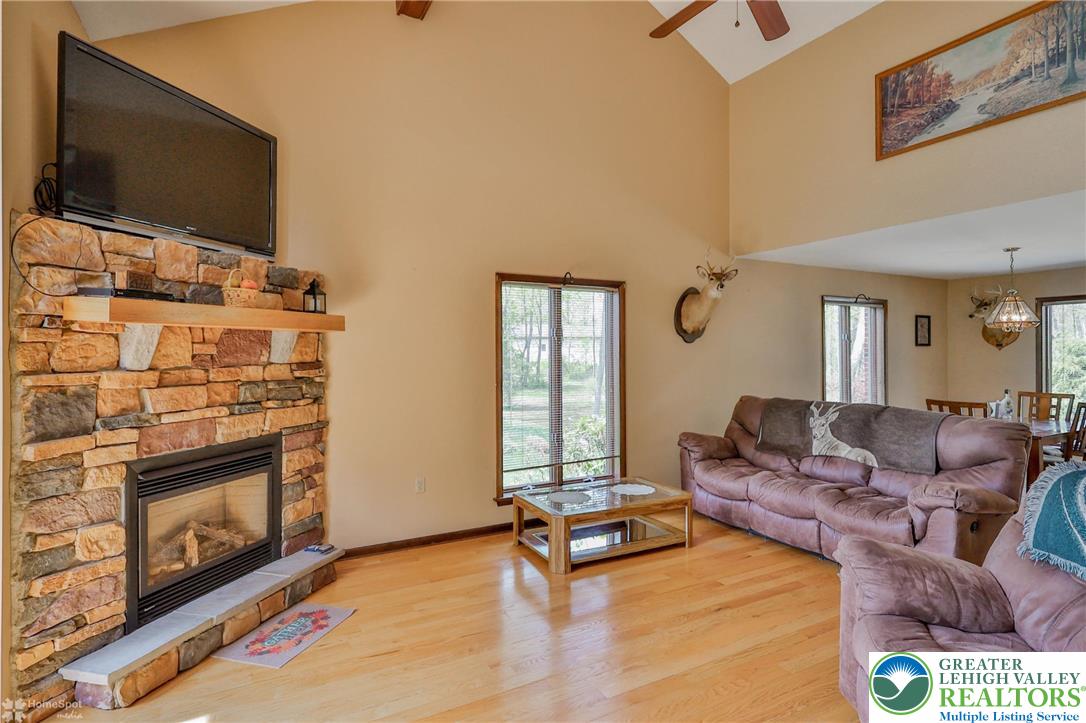 1208 Rone Drive Wind Gap, PA 18091 - Photo 13 of 78 a living room with furniture a flat screen tv and a fireplace