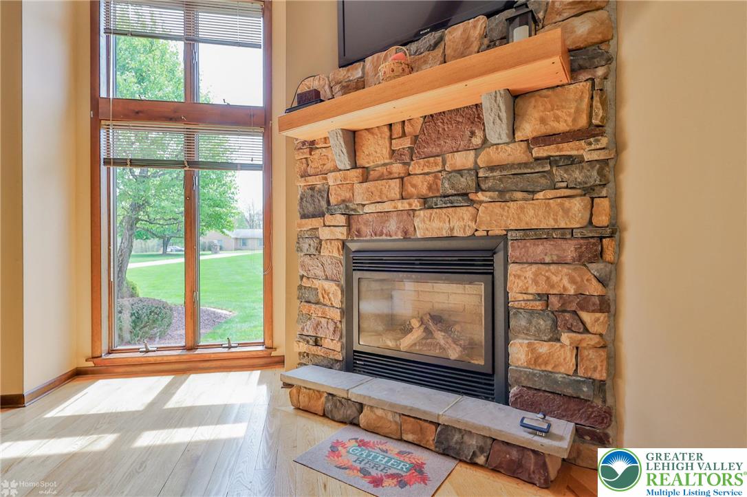 1208 Rone Drive Wind Gap, PA 18091 - Photo 19 of 78 a living room with a fireplace and a floor to ceiling window