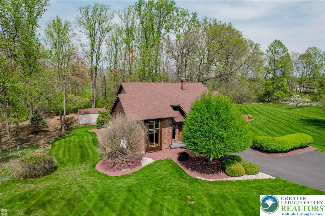 1208 Rone Drive Wind Gap, PA 18091 - Photo 2 of 78 a front view of a house with a garden and trees