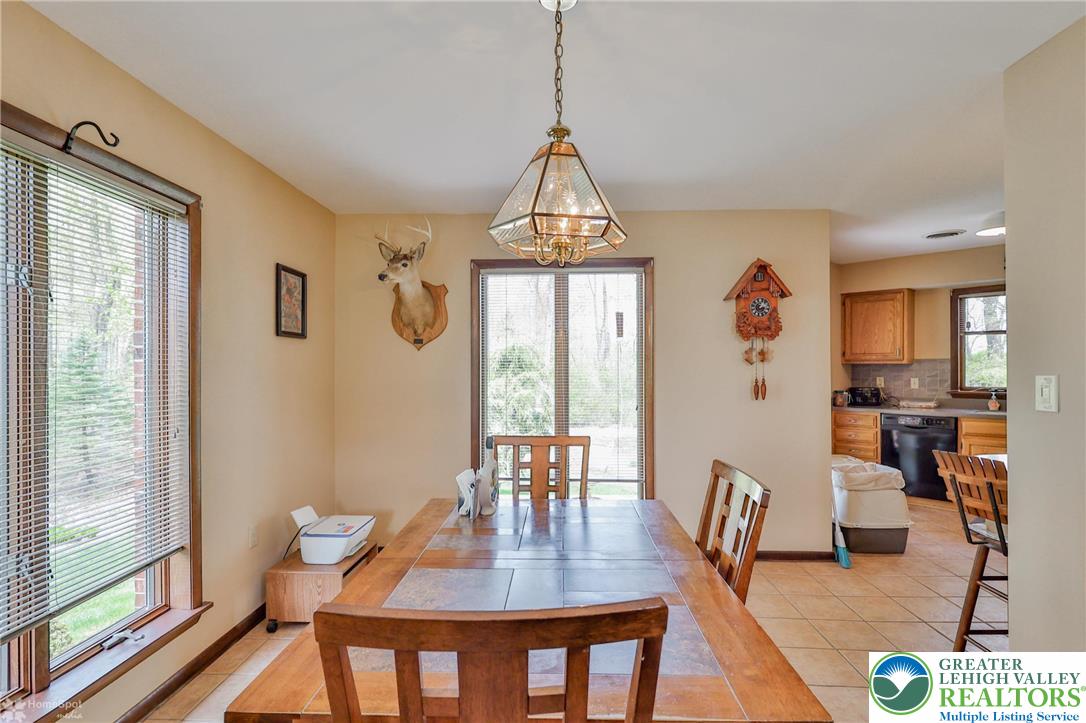1208 Rone Drive Wind Gap, PA 18091 - Photo 22 of 78 a dining room with furniture a chandelier and wooden floor