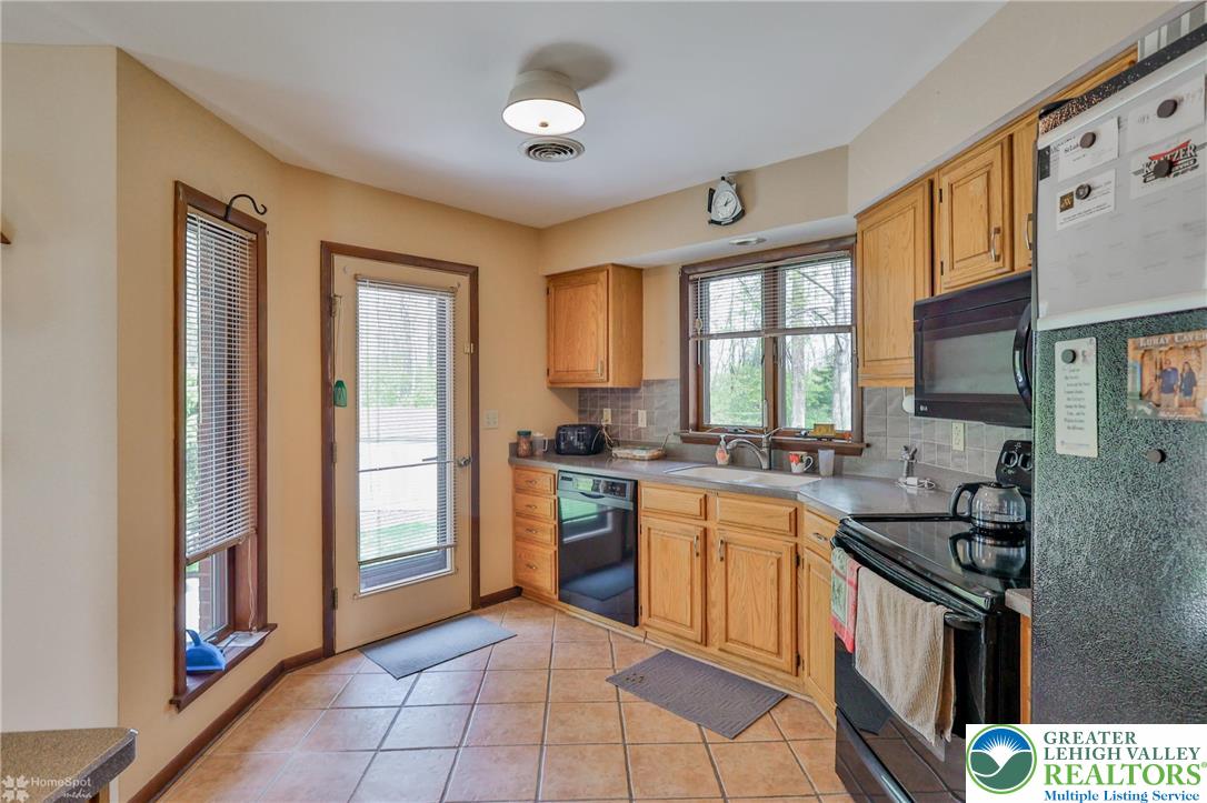 1208 Rone Drive Wind Gap, PA 18091 - Photo 26 of 78 a kitchen with a sink stove top oven and refrigerator