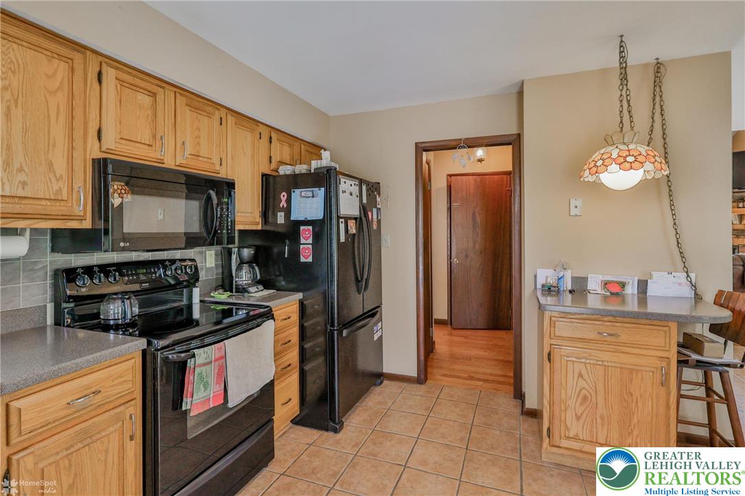 1208 Rone Drive Wind Gap, PA 18091 - Photo 27 of 78 a kitchen with stainless steel appliances granite countertop a stove a refrigerator and a microwave